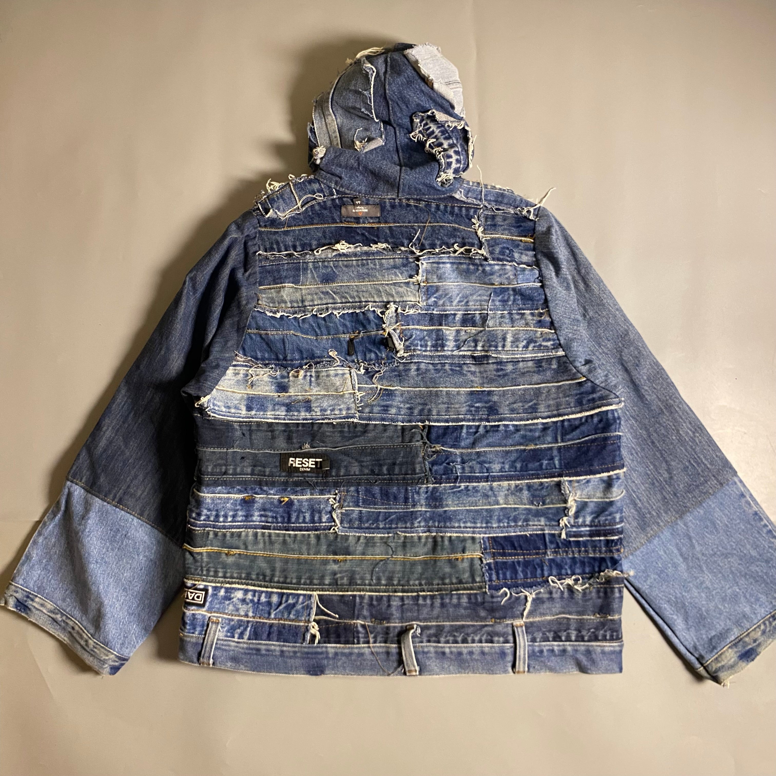 Custom upcycled patchwork denim jacket with a hoodie