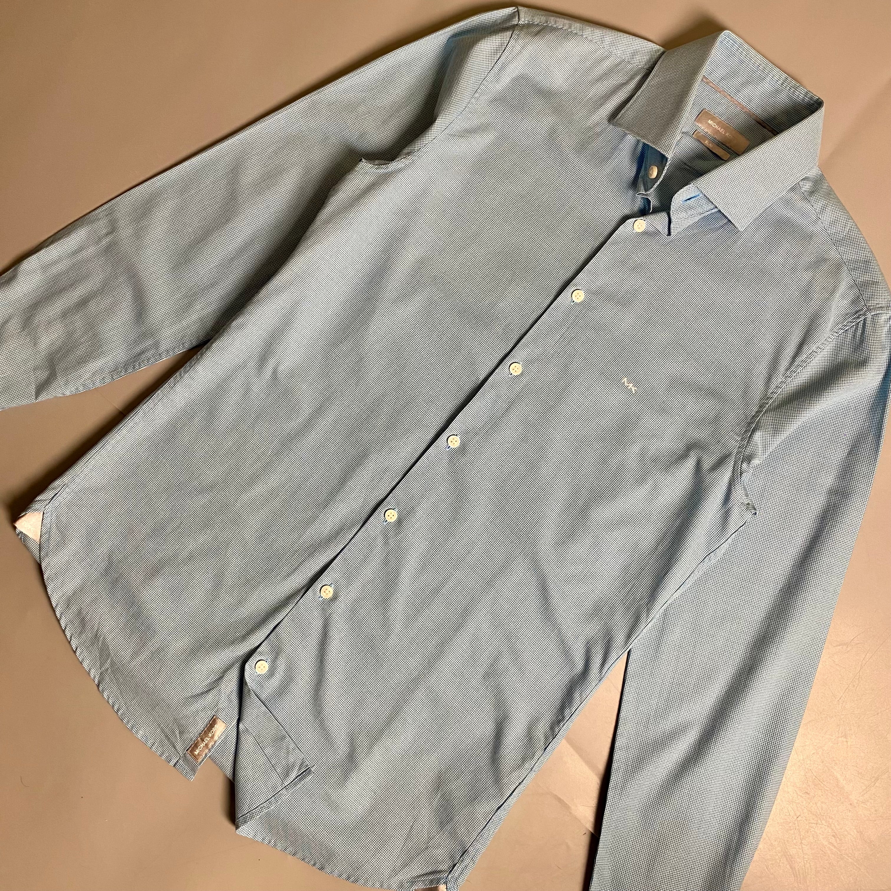 Michael Kors light blue long-sleeve &nbsp;shirt featuring a subtle micro-pattern and embroidered MK logo on the chest