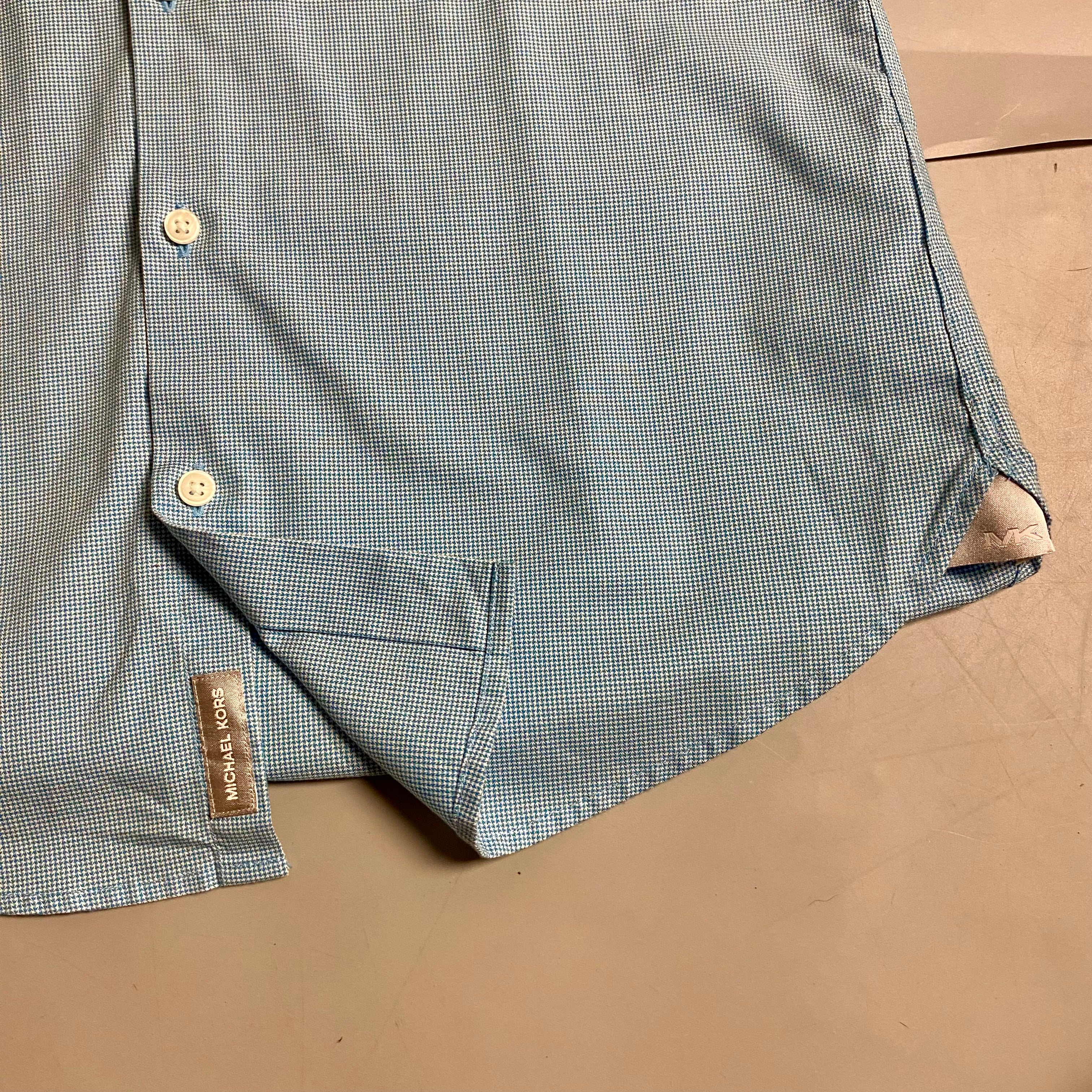 Michael Kors light blue long-sleeve &nbsp;shirt featuring a subtle micro-pattern and embroidered MK logo on the chest