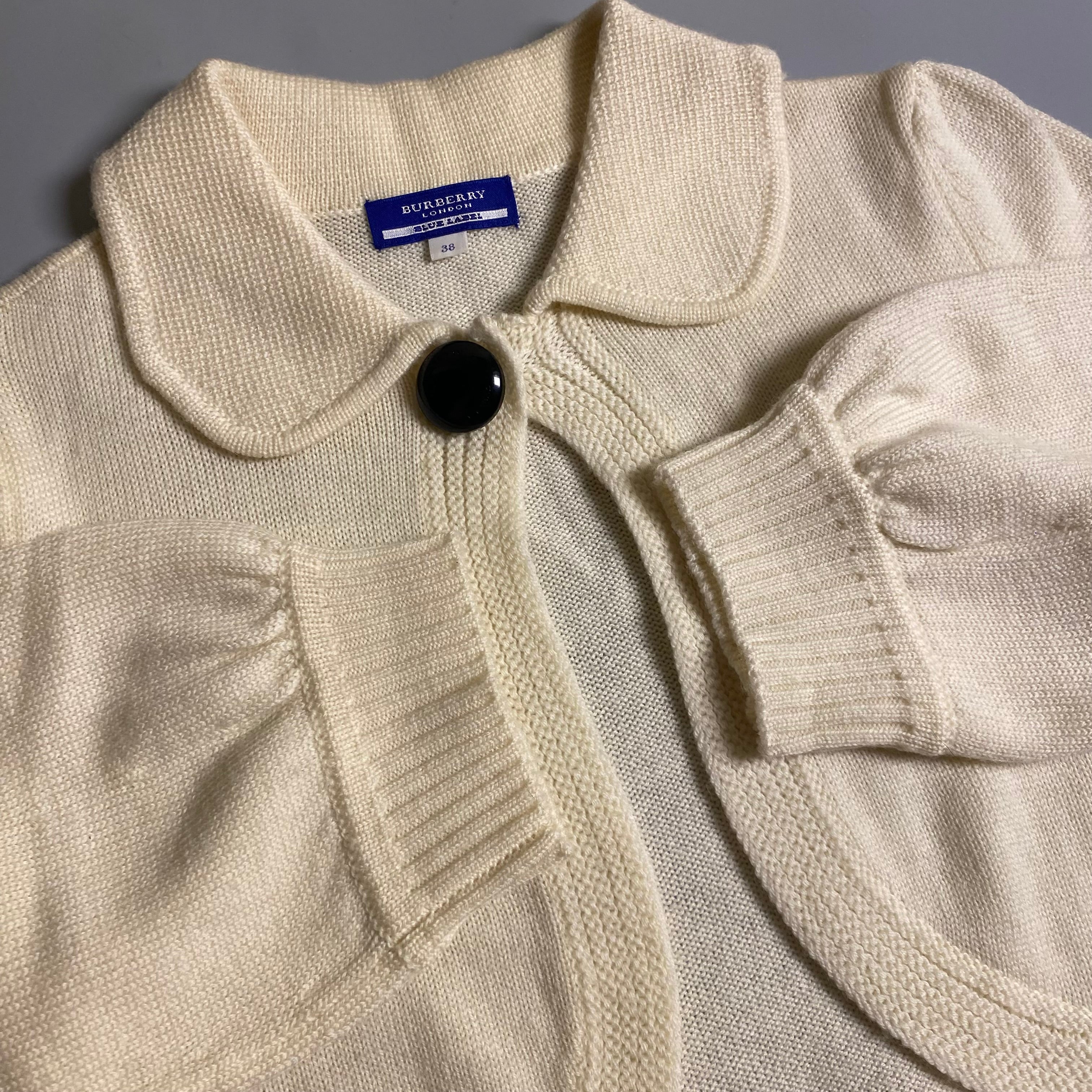 Burberry Blue Label cream knit cropped cardigan with a single button closure