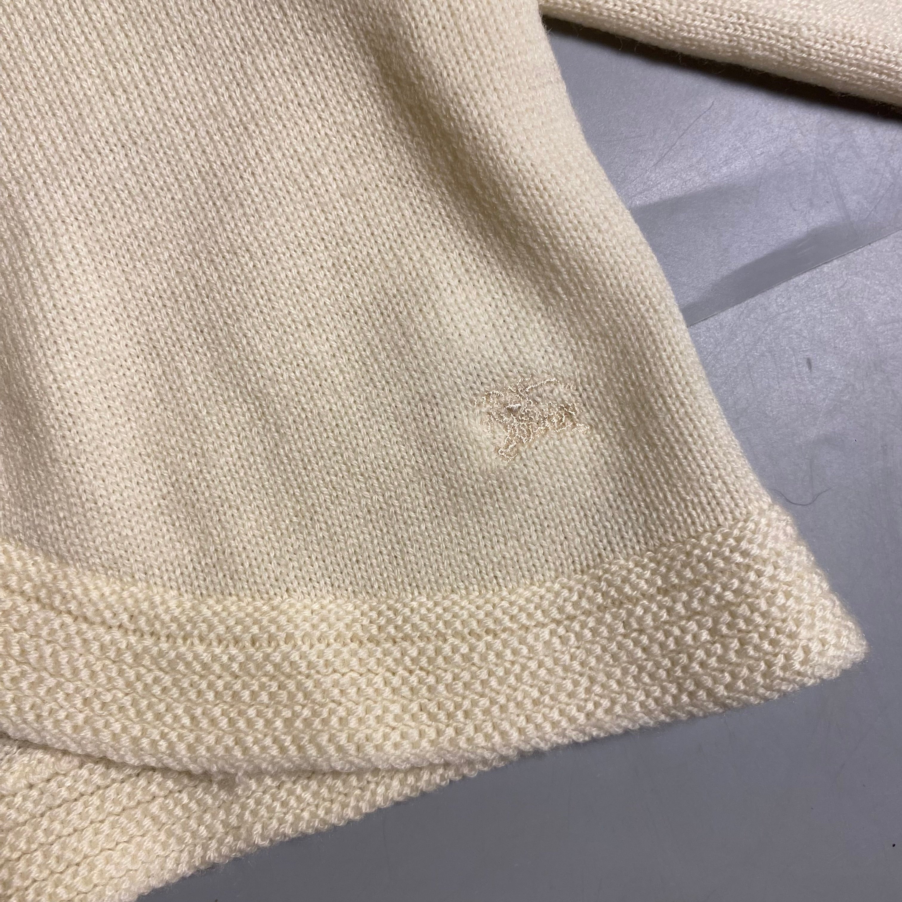 Burberry Blue Label cream knit cropped cardigan with a single button closure