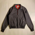 Fred Perry Made In England Harrington Jacket in black with a red tartan lining