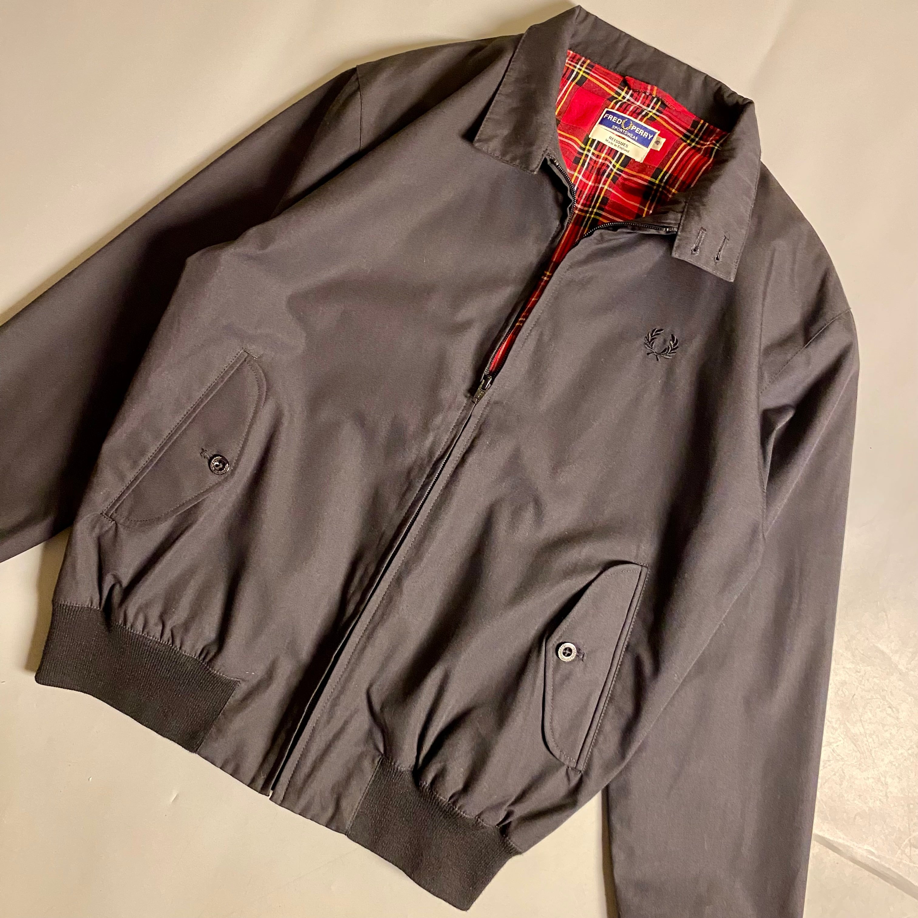 Fred Perry Made In England Harrington Jacket in black with a red tartan lining