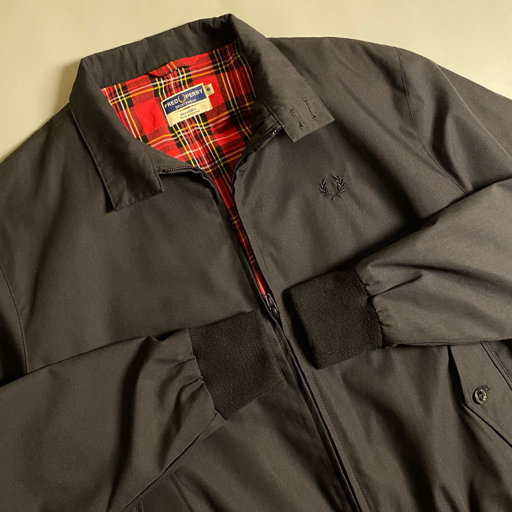Fred Perry Made In England Harrington Jacket in black with a red tartan lining