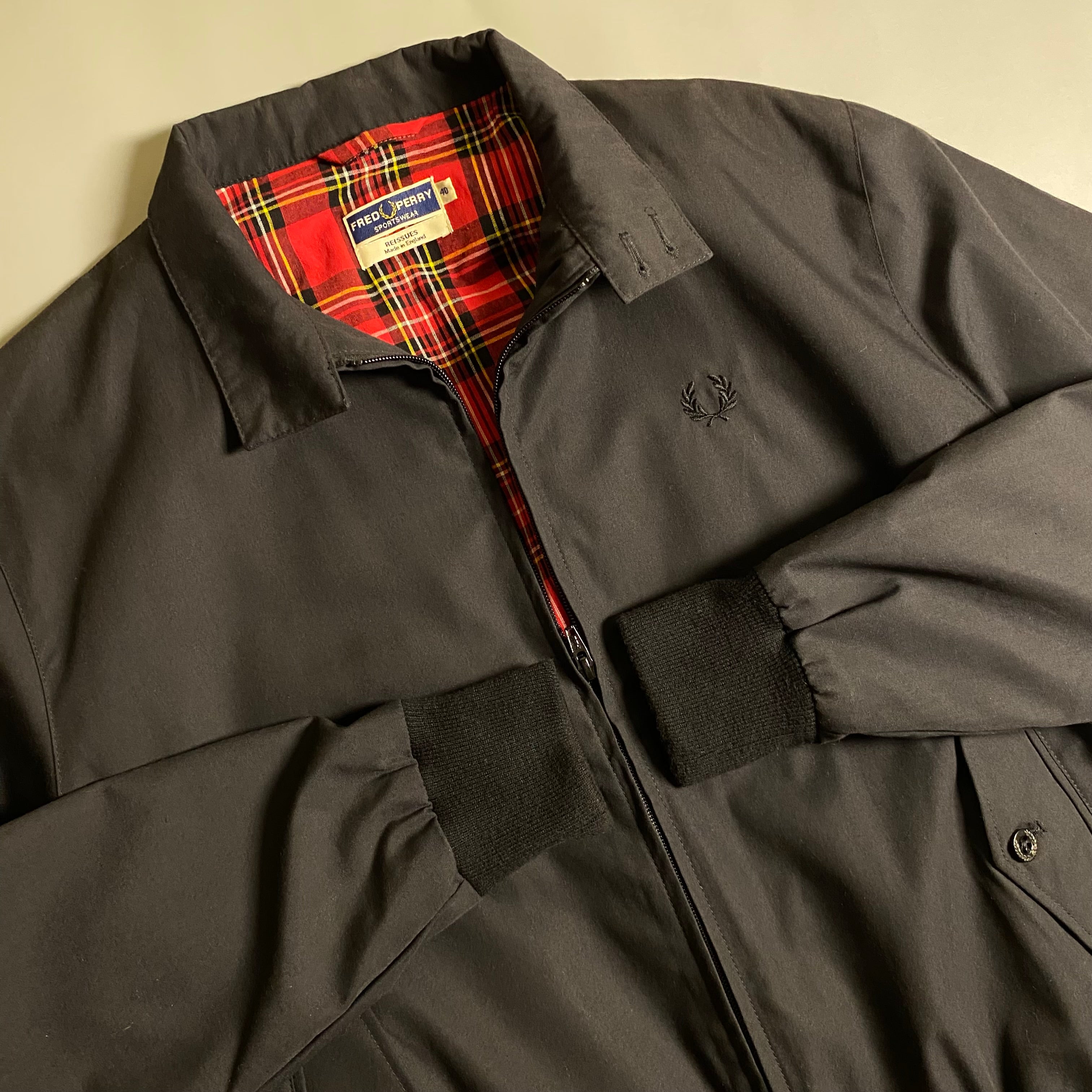 Fred Perry Made In England Harrington Jacket in black with a red tartan lining