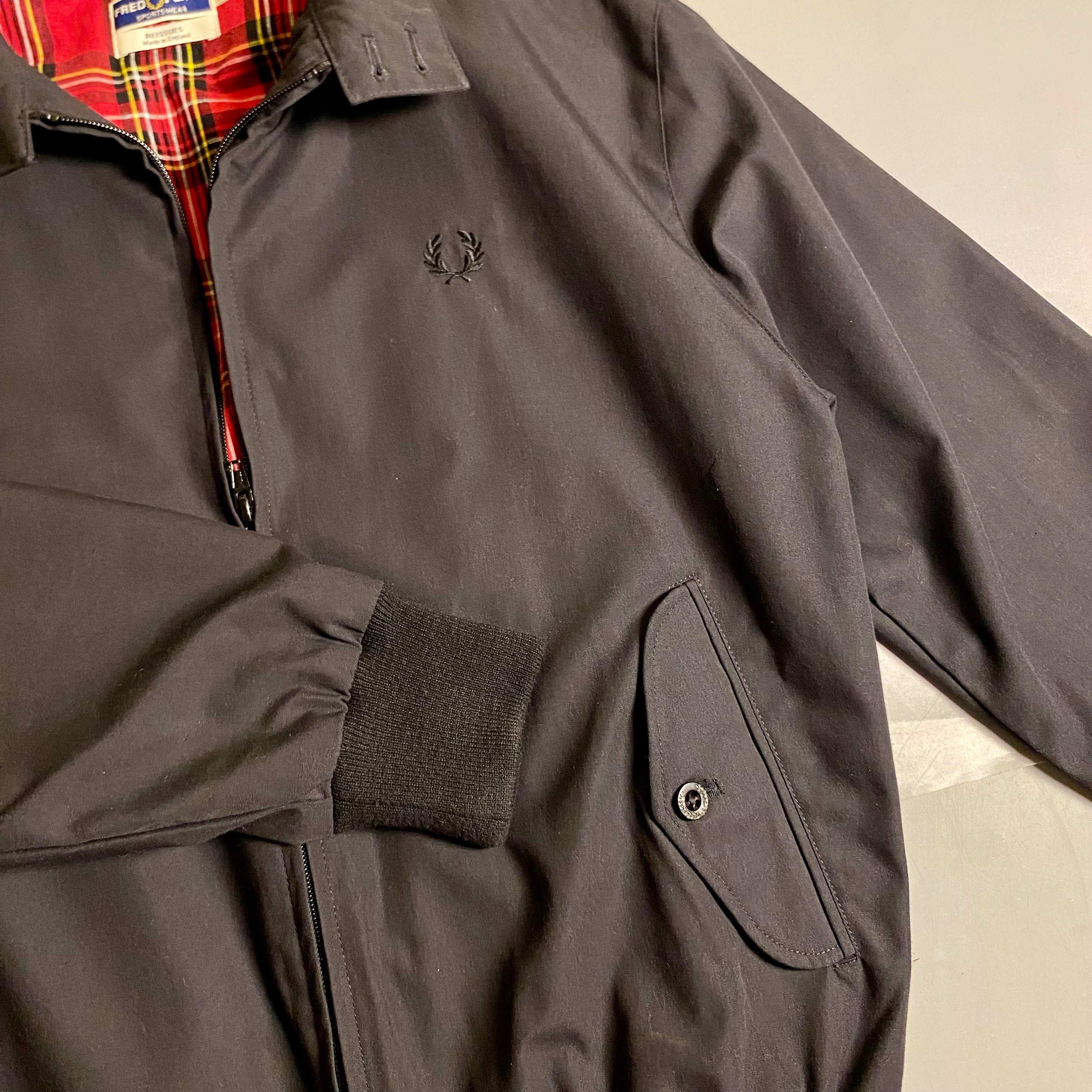 Fred Perry Made In England Harrington Jacket in black with a red tartan lining